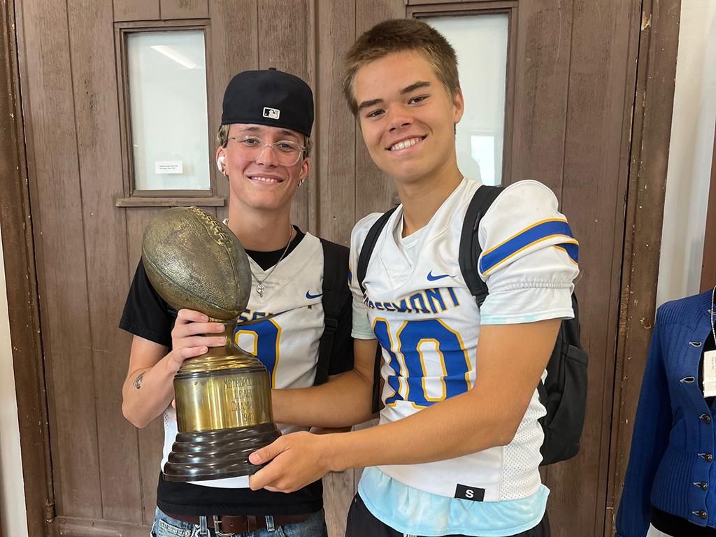 August 2024 Senior Kicker Dylan Gary and Quarterback Thomas Donovan  Holding the 1947 Metropolitan League Trophy